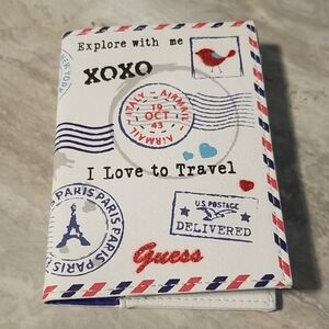 Guess Travel-Themed Passport Cover in Red, Blue, and White See Ad
